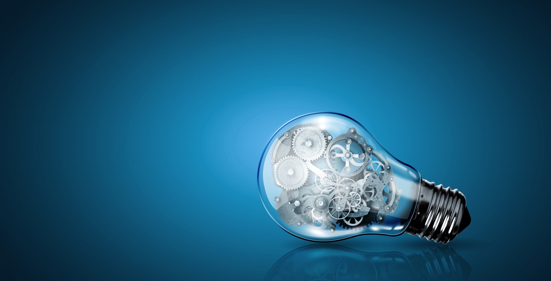 Conceptual image of light bulb with cogwheels inside