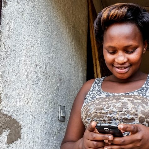 Woman mobile money east africa laterite