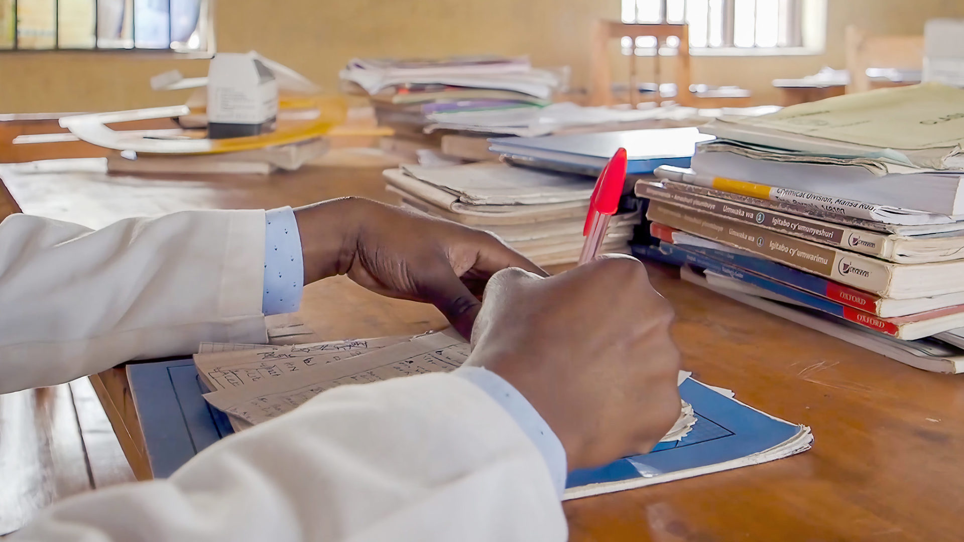 Teacher grading homework in rwanda source gpe via flickr