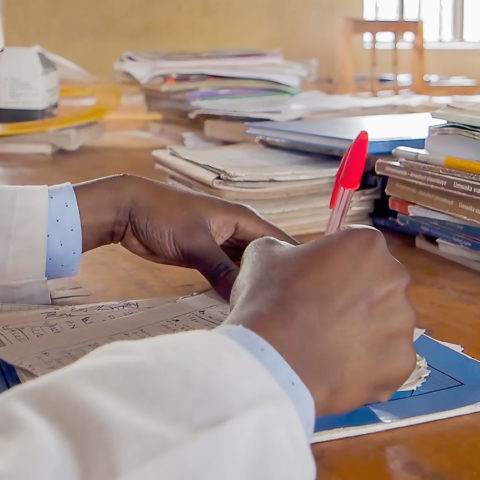 Teacher grading homework in rwanda source gpe via flickr